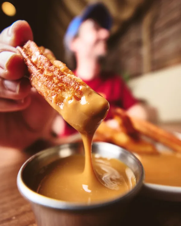 Churro dipped in sauce